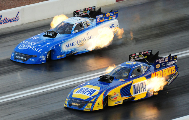 Funny Car drivers Ron Capps, nottom, and Tommy Johnson Jr. race side by side during qualifying for the NHRA Mello Yello Series Toyota Nationals at The Strip at Las Vegas Motor Speedway in Las Vega ...