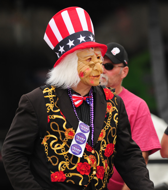 A fan dressed in a Halloween costume walks in the paddock in between qualifying sessions for the NHRA Mello Yello Series Toyota Nationals at The Strip at Las Vegas Motor Speedway in Las Vegas Frid ...