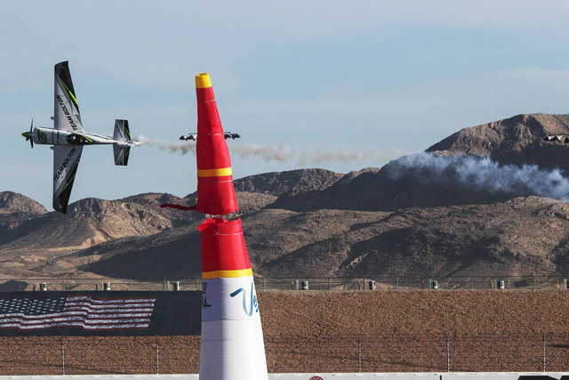 Chilean pilot Cristian Bolton hits a pylon race marker as he flies an Edge 540 V2 on the final day of the Red Bull Air Race World Championship at the Las Vegas Motor Speedway, Sunday, Oct. 16, 201 ...