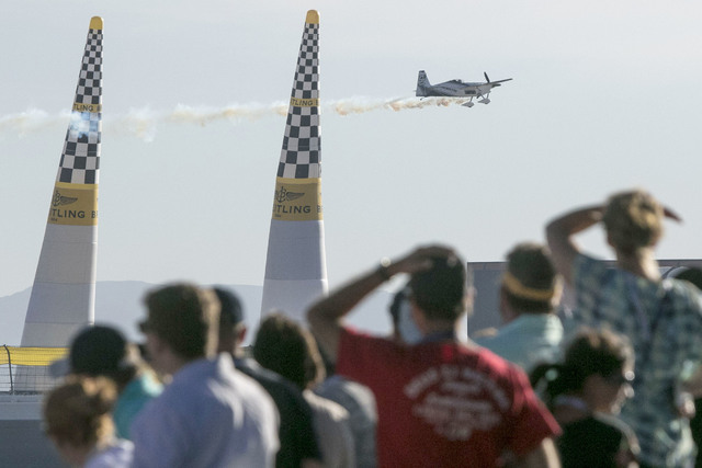 A crowd watches as Chilean pilot Cristian Bolton crosses the finish line on the final day of the Red Bull Air Race World Championship at the Las Vegas Motor Speedway, Sunday, Oct. 16, 2016. (Richa ...