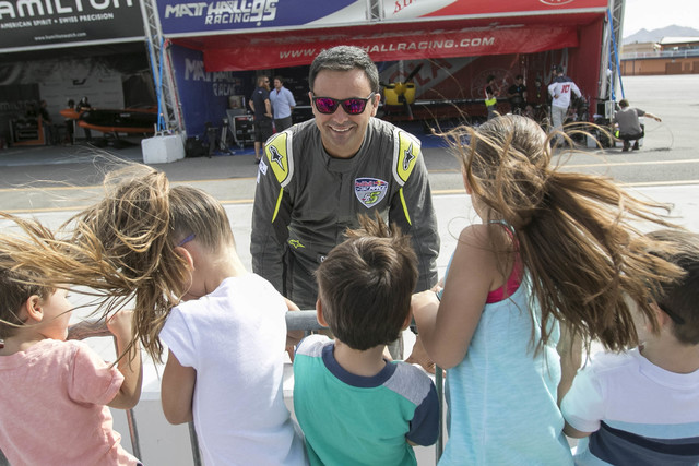 Chilean air race pilot Cristian Bolton greets a group of youngsters on the final day of the Red Bull Air Race World Championship at the Las Vegas Motor Speedway, Sunday, Oct. 16, 2016. (Richard Br ...