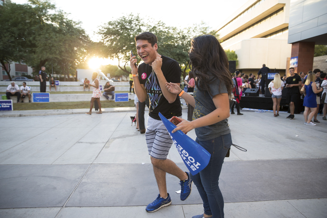 UNLV students Jason Meza, left, and Denise Zamora, react after taking a photograph with music artist Katy Perry after her speech during a campaign rally for Democratic presidential nominee Hillary ...