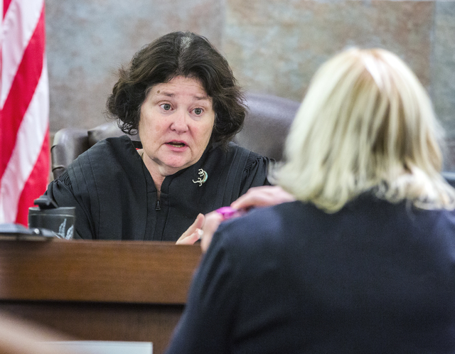 District Judge Elizabeth Gonzalez ,left, talks to defense attorney Lisa Rasmussen during the death penalty trial of defendant Eric Covington at Regional Justice Center on Friday, Oct.14, 2016.  Co ...