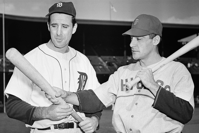 Detroit Tigers left fielder Hank Greenberg, left, and Chicago Cubs first baseman Phil Cavarretta, whose powerful bats were a decisive factor in squaring off the first and second World Series game  ...
