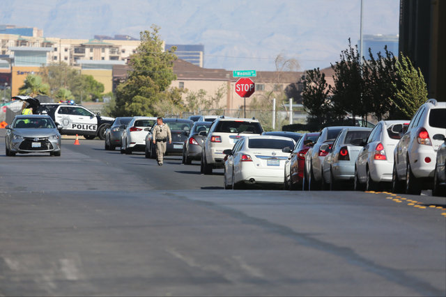 Traffic backs up near a CVS Pharmacy at the intersection of Las Vegas Boulevard and Windmill Lane, where police arrested the suspect of a shooting on I-15, in Las Vegas on Saturday, Oct. 15, 2016. ...