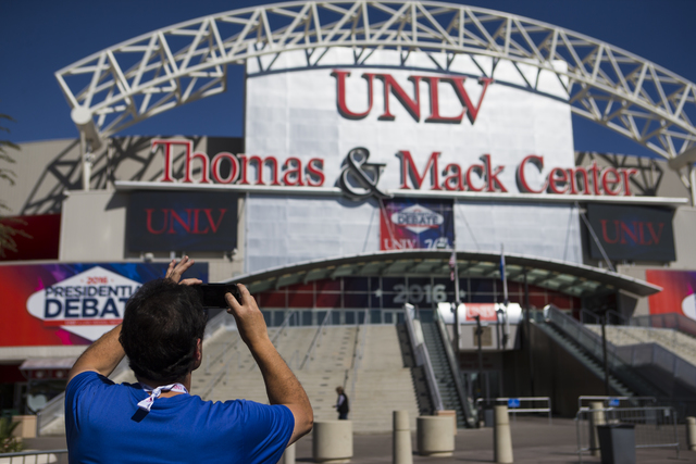 A man takes a photo of the Thomas & Mack Center ahead of the third presidential debate at UNLV in Las Vegas on Tuesday, Oct. 18, 2016. Chase Stevens/Las Vegas Review-Journal Follow @csstevensphoto