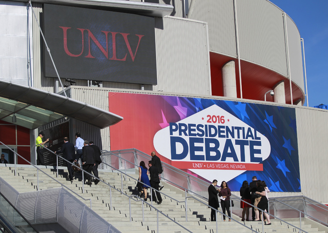 People walk outside of the Thomas & Mack Center ahead of the third presidential debate at UNLV in Las Vegas on Wednesday, Oct. 19, 2016. Chase Stevens/Las Vegas Review-Journal Follow @cssteven ...