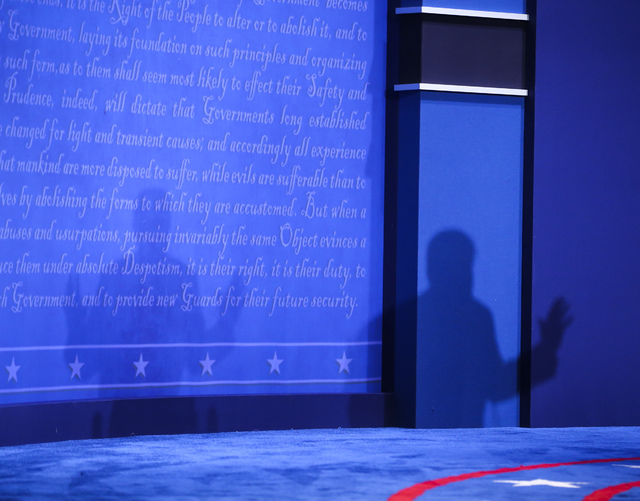 A shadow is cast while Republican presidential candidate Donald Trump speaks during the third presidential debate at the Thomas & Mack Center at UNLV in Las Vegas on Wednesday, Oct. 19, 2016.  ...