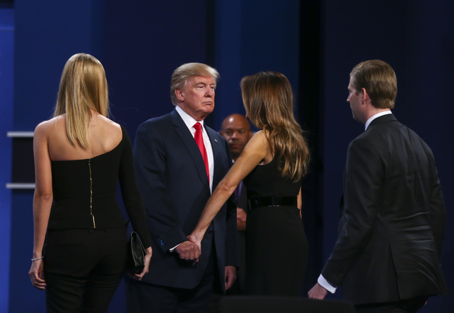 Republican presidential candidate Donald Trump greets his wife Melania Trump along with the rest of his family following the third presidential debate at the Thomas & Mack Center at UNLV in La ...
