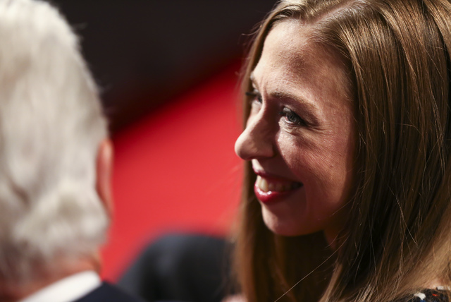 Chelsea Clinton talks to her father, former President Bill Clinton, before the third presidential debate begins at the Thomas & Mack Center at UNLV in Las Vegas on Wednesday, Oct. 19, 2016. Ch ...