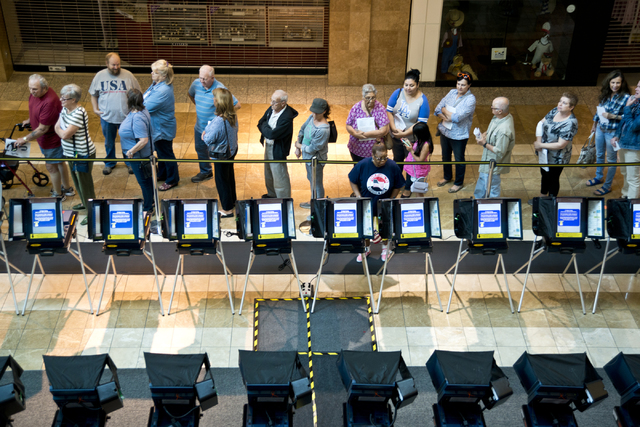 Voters stand in line to be among the first to vote in Nevada during early voting at the Galleria at Sunset in Henderson on Saturday morning, Oct. 22, 2016. Daniel Clark/Las Vegas Review-Journal Fo ...