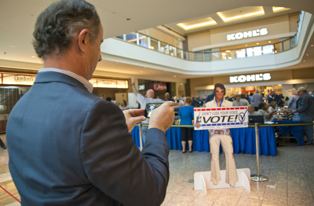 Gary Rhoades of the Nevada Democratic Party takes a photo of a stand-up Elvis sign during early voting at the Galleria at Sunset in Henderson on Saturday morning, Oct. 22, 2016. Daniel Clark/Las V ...