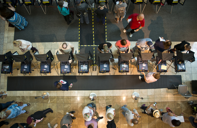 Voters cast ballots and stand in line to be among the first to vote in Nevada at the Galleria at Sunset in Henderson on Saturday morning, Oct. 22, 2016. Daniel Clark/Las Vegas Review-Journal Follo ...