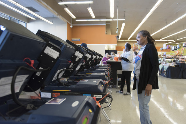 Volunteer Regina Dennis waits to assist voters during early voting at Albertsons at 2885 E. Desert Inn Rd. in Las Vegas, Saturday, Oct. 22, 2016. Jason Ogulnik/Las Vegas Review-Journal
