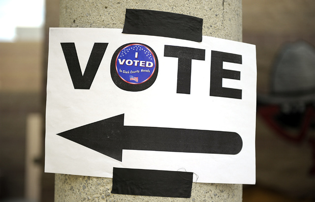 A directional sign is embellished with an "I voted" sticker at Del E. Webb Middle School in Anthem on Tuesday, June 10, 2014. By 8:30am, 29 voters had cast their votes at the Web ...