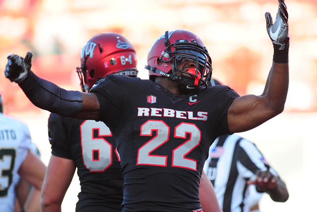 UNLV Rebels running back David Greene (22) celebrates after scoring a touchdown while being wrapped against Colorado State in the second half of their NCCA college football game at Sam Boyd Stadiu ...