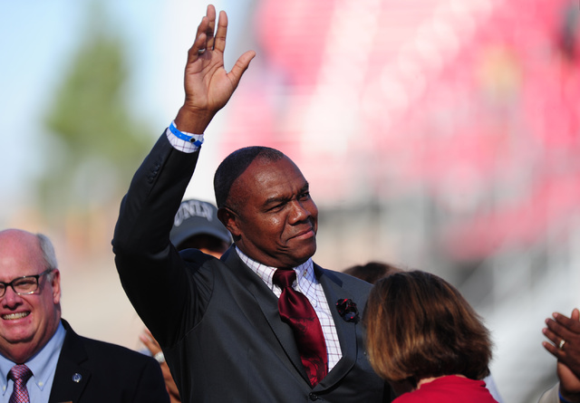 Former UNLV Rebels quarterback Randall Cunningham is honored with a plaque from the College Football Hall of Fame their NCAA college football game against the Colorado State Rams at Sam Boyd Stadi ...