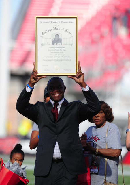 Former UNLV Rebels quarterback Randall Cunningham is honored with a plaque from the College Football Hall of Fame their NCAA college football game against the Colorado State Rams at Sam Boyd Stadi ...