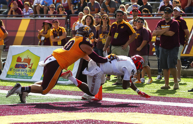 UNLV wide receiver Darren Woods Jr. (10) scores a touchdown as Central Michigan linebacker Alex Briones (30) defends during a football game at Kelly/Shorts Stadium in Mount Pleasant, Mich. on Satu ...