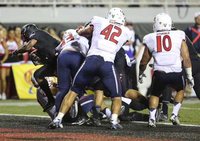 UNLV tight end Trevor Kanteman (9) breaks free from Fresno State linebacker's Josh Hokit (33), Jeff Camilli (42) and Nela Otukolo (10) to score a touchdown during a football game at Sam Boyd Stadi ...