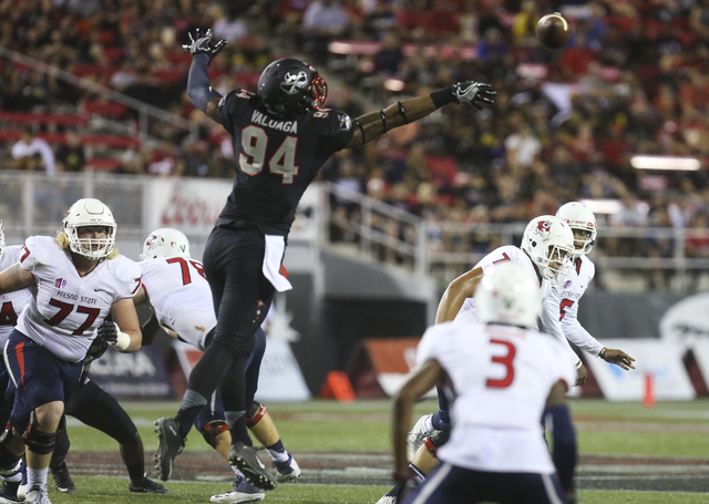 UNLV defensive lineman Jeremiah Valoaga (94) attempts to intercept a pass during a football game against Fresno State at Sam Boyd Stadium in Las Vegas on Saturday, Oct. 1, 2016. Miranda Alam/Las ...