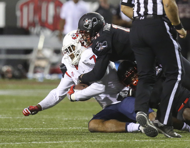 Fresno State wide receiver Aaron Peck (7) gets tackled by UNLV defensive back Troy Hawthorne (11) during a football game at Sam Boyd Stadium in Las Vegas on Saturday, Oct. 1, 2016. Miranda Alam/La ...