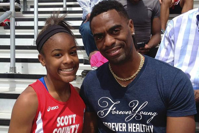 Trinity Gay poses with her father U.S. sprinter Tyson Gay in May. (Mark Maloney/Lexington Herald-Leader via AP)