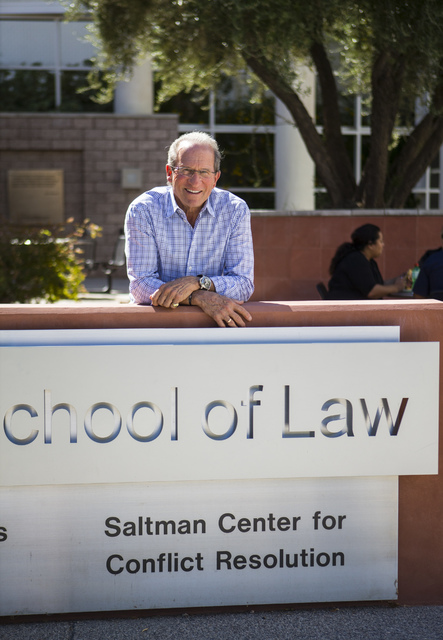 Michael Saltman, managing general partner and president of The Vista Group, poses for a photo next to a sign for the Saltman Center for Conflict Resolution outside of the William S. Boyd School of ...