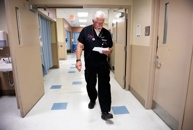 University Medical Center Chief of Staff Dr. Dale Carrison checks his notes as he makes his rounds in the emergency department at the hospital Monday, Oct. 24, 2016, in Las Vegas. Carrison, a 26-y ...