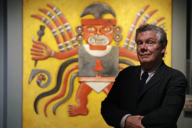 Jeffrey Quilter, director at the Peabody Museum of Archaeology & Ethnology, poses in front of reproduction of a Peruvian Decapitator God, at Harvard University. The Peabody, one of the oldest  ...