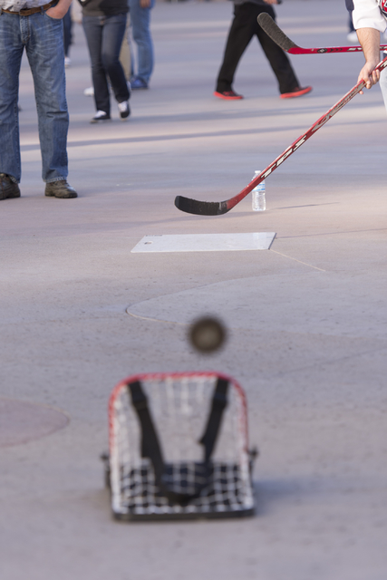 A man hits a puck into a net during the Vegas Hockey Fan Fest at Toshiba Plaza in Las Vegas, Saturday, Oct. 8, 2016. Jason Ogulnik/Las Vegas Review-Journal