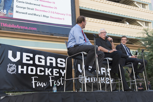Las Vegas NHL franchise owner Bill Foley, center, and general manager George McPhee, right, talk on stage during the Vegas Hockey Fan Fest at Toshiba Plaza in Las Vegas, Saturday, Oct. 8, 2016. Ja ...