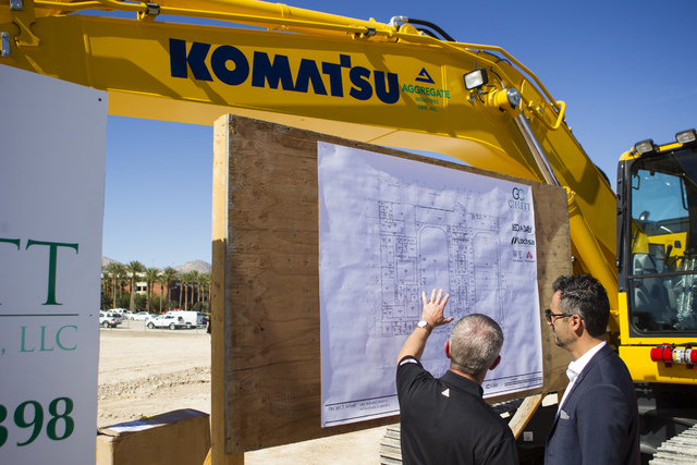 Kerry Bubolz, president of Las Vegas' NHL expansion team, left, looks at the blueprints after the groundbreaking ceremony for the team's practice facility and headquarters in Las Vegas on Wednesda ...