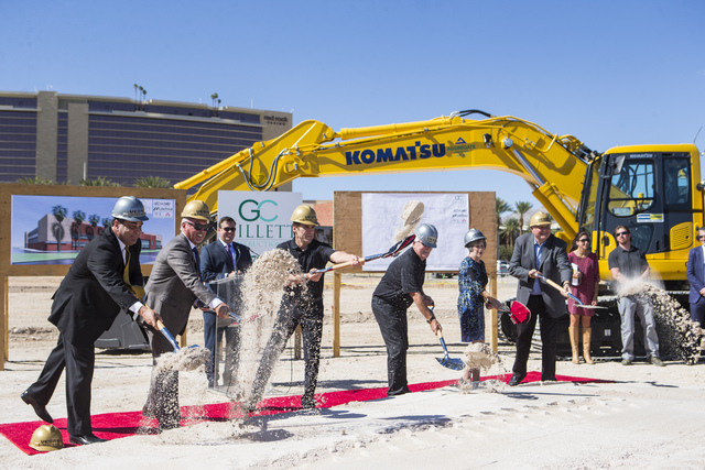Bill Foley, the owner of Las Vegas' NHL expansion team, fifth from left, shovels dirt with other officials during the groundbreaking ceremony for the team's practice facility and headquarters in L ...