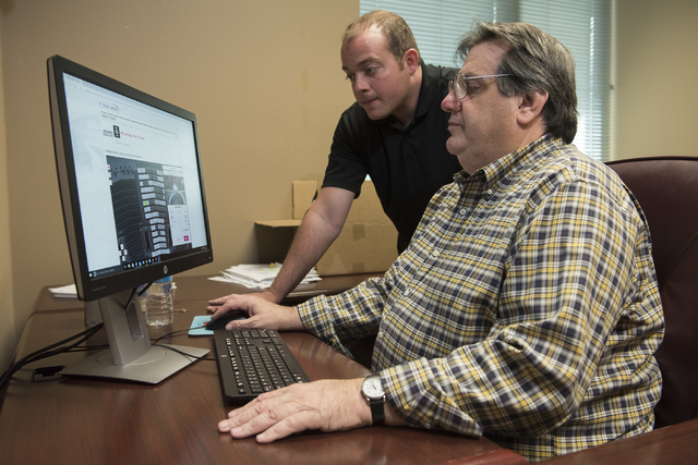 Todd Pollock, top, Vice President of Ticketing and Suites for the new Las Vegas hockey team shows Review-Journal reporter Steve Carp the process of purchasing season tickets from their NHL office ...