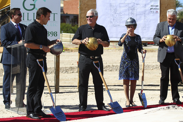Bill Foley, owner of Las Vegas' NHL expansion team,  center, talks with George McPhee, general manager of the team, during the groundbreaking ceremony for the team's practice facility and headquar ...