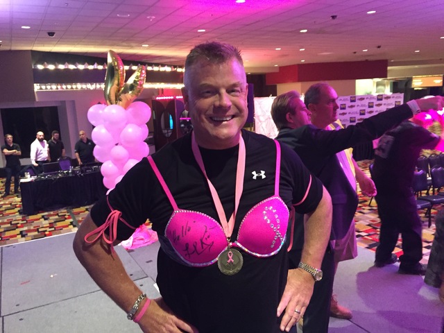 Planet Hollywood President David Hoenemeyer models a bra signed by Lionel Richie, which commanded a $22,000 bid during the hotel's annual "Battle of the Bras" fundraiser on Oct. 19. (Dayna Roselli ...