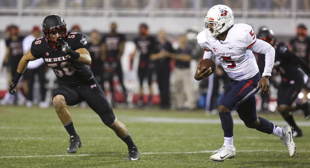 UNLV linebacker Ryan McAleenan (56) looks to stop Fresno State quarterback Chason Virgil (5) during a football game at Sam Boyd Stadium in Las Vegas on Saturday, Oct. 1, 2016. Miranda Alam/Las Veg ...