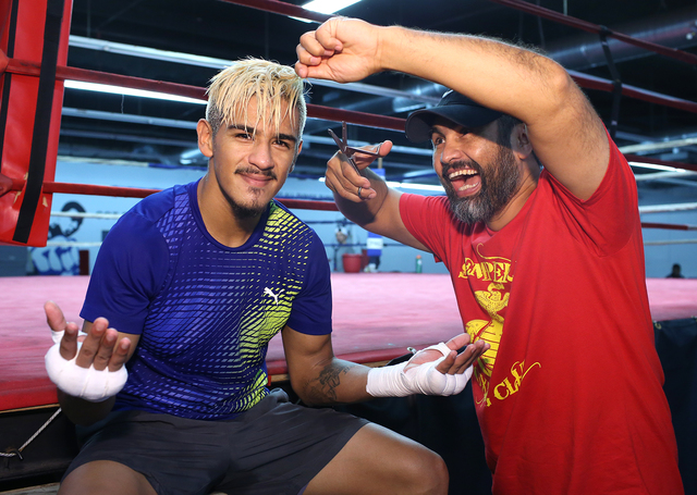 Las Vegan Jessie Magdaleno (left) and his trainer Manny Robles joke around after a workout last week. (Mikey Williams)