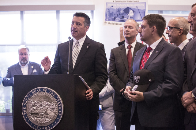 Nevada Gov. Brian Sandoval, left, address the crowd moments before signing Senate Bill 1 at the Richard TAM Alumni Center at UNLV on Monday, Oct. 17, 2016, in Las Vegas. The bill officially allows ...