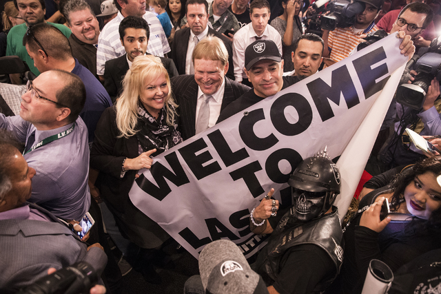 Oakland Raiders owner Mark Davis, middle, celebrates with supporters moments after Gov. Brian Sandoval signed Senate Bill 1 at the Richard TAM Alumni Center at UNLV on Monday, Oct. 17, 2016, in La ...
