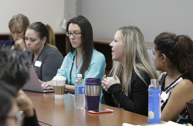Grace Ravenelle, M.S. clinical mental health counseling, second right, speaks during a staff meeting with professors and students who are training to be psychologists, Thursday, Oct. 6, 2016, at m ...