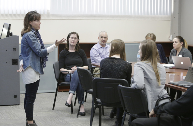 Dr. Michelle Paul speaks as Dr. Noelle Lefforge, second, left, looks on during a staff meeting with professors and students who are training to be psychologists, Thursday, Oct. 6, 2016, at mental  ...