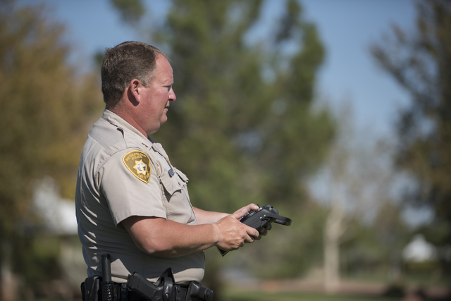 Las Vegas police officer Dave Martel operates a Typhoon Q500 drone during a demonstration about the safe operation of unmanned aircraft systems during a news conference at Police Memorial Park in  ...