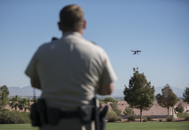 Las Vegas police officer Dave Martel operates a Typhoon Q500 drone during a demonstration about the safe operation of unmanned aircraft systems during a news conference at Police Memorial Park in ...