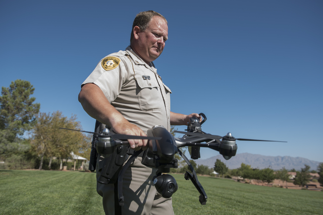 Las Vegas police officer Dave Martel prepares a Typhoon Q500 drone during a demonstration about the safe operation of unmanned aircraft systems during a news conference at Police Memorial Park in  ...