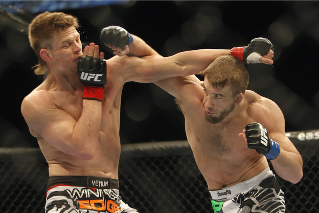 Mike Pyle, left, and TJ Waldburger fight during UFC 170 at the Mandalay Bay Events Center in Las Vegas on Saturday night, Feb. 22, 2014.  (Jason Bean/Las Vegas Review-Journal)
