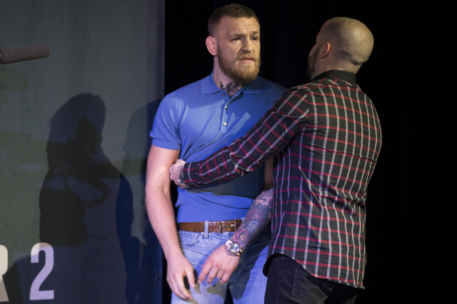 Conor McGregor is held back from an altercation with his team and that of his opponent Nate Diaz during the UFC 202 press conference at the MGM Grand hotel-casino on Wednesday, Aug. 17, 2016, in L ...