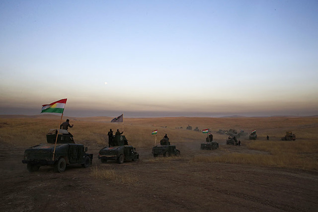 A Peshmerga convoy drives toward a frontline east of Mosul, Iraq, Monday, Oct. 17, 2016.  The Iraqi military and the country's Kurdish forces say they launched operations to the south and east of  ...