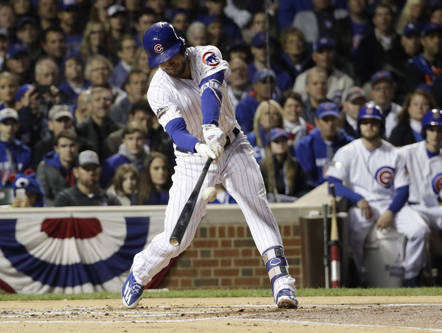 Chicago Cubs third baseman Kris Bryant (17) hits an RBI single during the first inning of Game 6 of the National League baseball championship series against the Los Angeles Dodgers, Saturday, Oct. ...